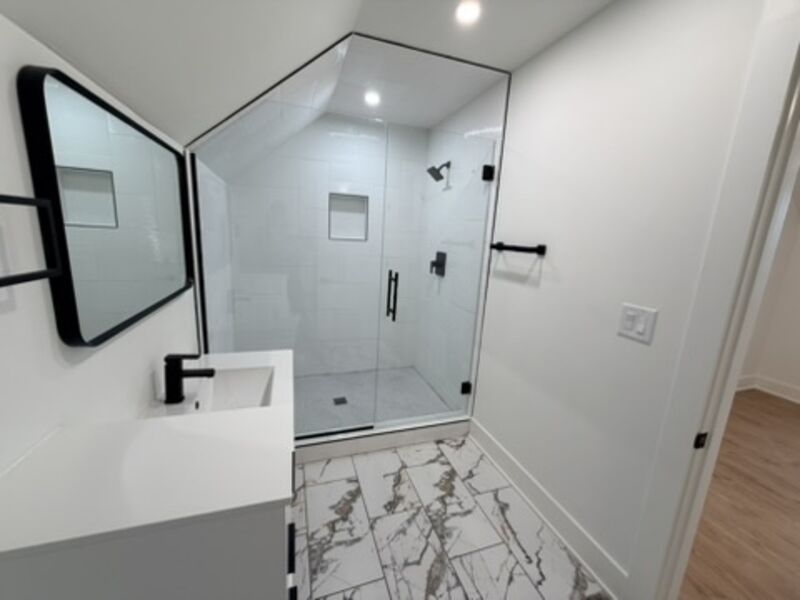 Fully tiled shower with glass enclosure