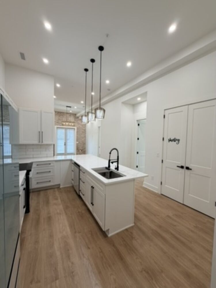 Kitchen with quartz island and pendant lights